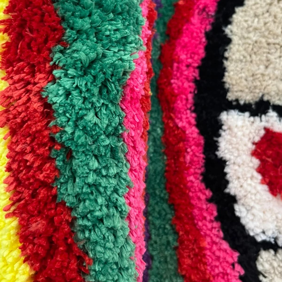 Colorful mushroom-shaped tufted rug with indie aesthetic, featuring vibrant stripes and plush texture