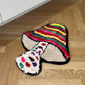 Colorful mushroom-shaped tufted rug with indie aesthetic, featuring vibrant stripes and plush texture