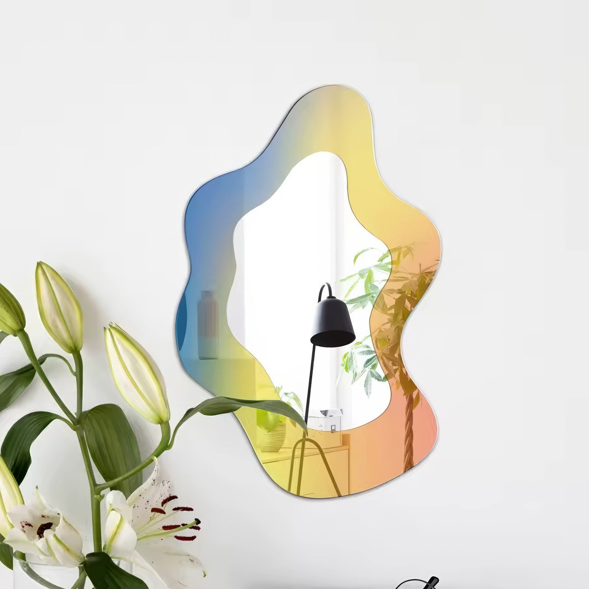 An abstract, wavy-edged acrylic mirror with a holographic iridescent finish that shifts between pink, purple, and light blue