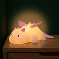 Cute white dragon silicone night light with pink or blue details and soft glowing body