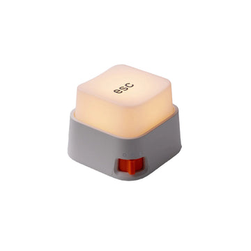 Rechargeable keyboard key-shaped LED night light with a soft warm glow, oversized mechanical keycap design, and tactile press switch for desks and bedside tables.