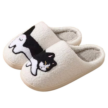 Pair of white plushie slippers with a black and white cat design