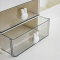 White plastic desk organizer with bunny drawer handles, two drawers, and six open compartments, sized 28.5cm x 17cm x 12cm.