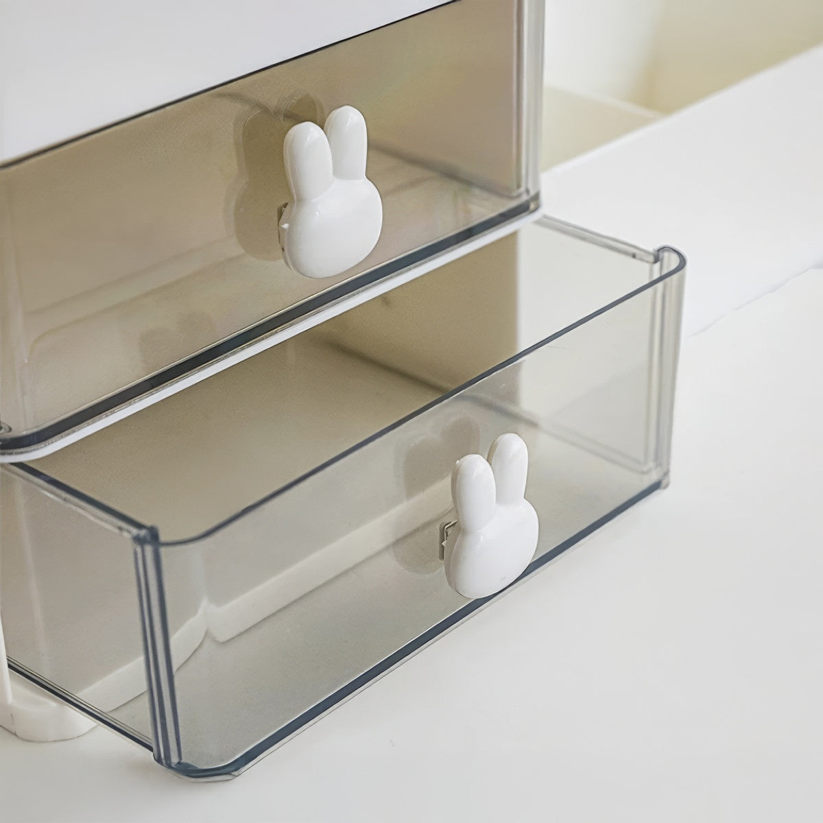 White plastic desk organizer with bunny drawer handles, two drawers, and six open compartments, sized 28.5cm x 17cm x 12cm.