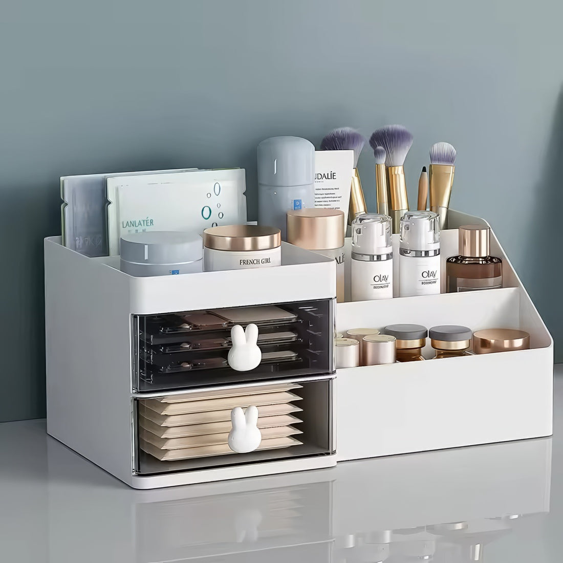 White plastic desk organizer with bunny drawer handles, two drawers, and six open compartments, sized 28.5cm x 17cm x 12cm.