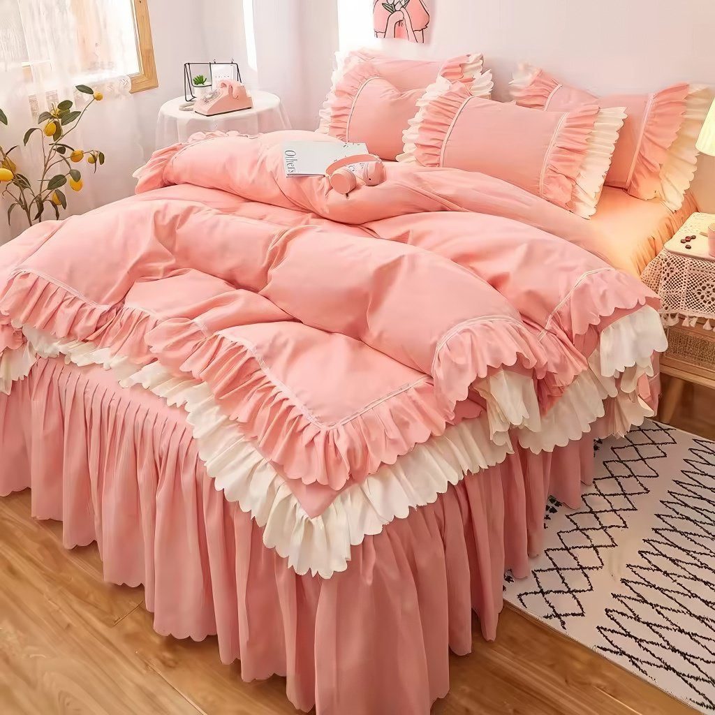 Pink ruffled bedding set with white frill trim, including a duvet cover, pillowcases, and bed skirt, in a soft and feminine coquette aesthetic