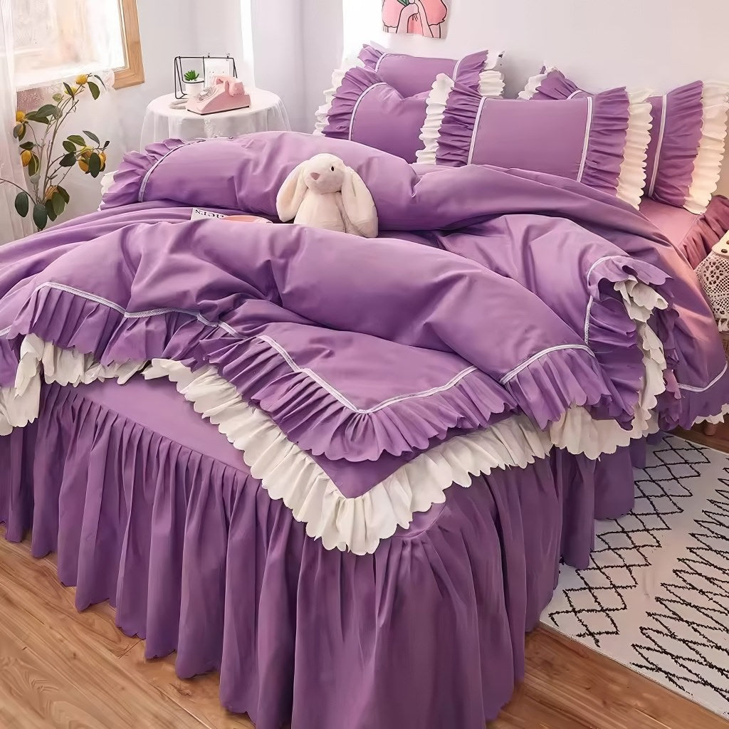 Pink ruffled bedding set with white frill trim, including a duvet cover, pillowcases, and bed skirt, in a soft and feminine coquette aesthetic