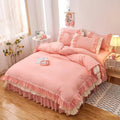 Pink ruffled bedding set with white frill trim, including a duvet cover, pillowcases, and bed skirt, in a soft and feminine coquette aesthetic