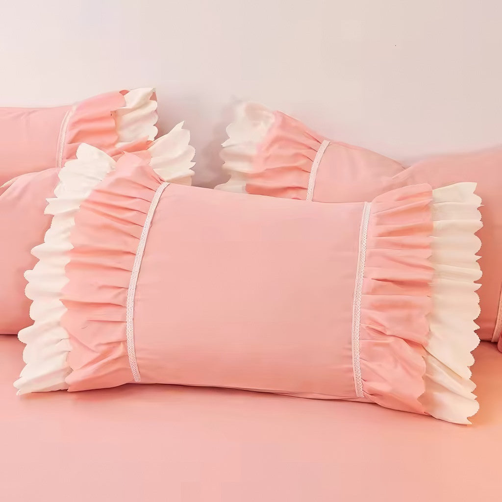 Pink ruffled bedding set with white frill trim, including a duvet cover, pillowcases, and bed skirt, in a soft and feminine coquette aesthetic