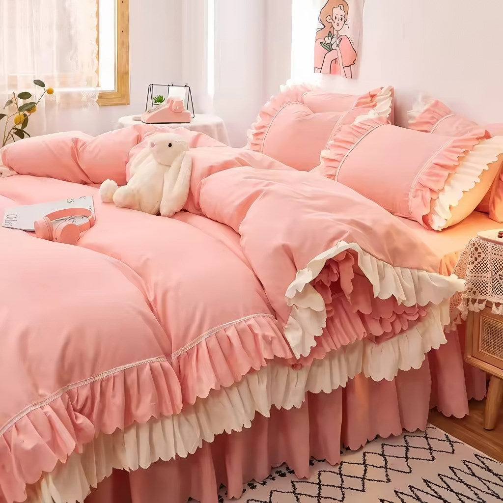 Pink ruffled bedding set with white frill trim, including a duvet cover, pillowcases, and bed skirt, in a soft and feminine coquette aesthetic