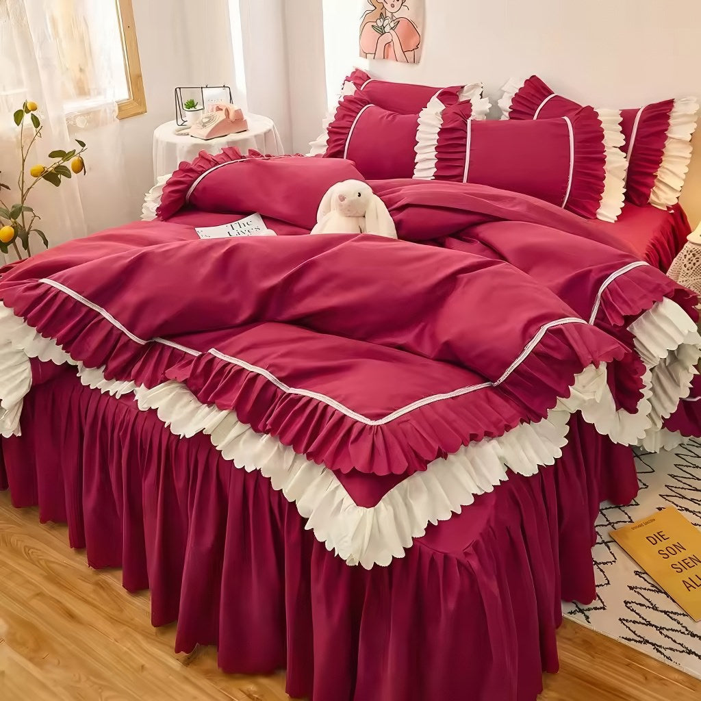 Pink ruffled bedding set with white frill trim, including a duvet cover, pillowcases, and bed skirt, in a soft and feminine coquette aesthetic