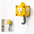 Two yellow block-style key hooks designed like Super Mario question blocks. Yellow Mystery Box hidden hook key holder with white question mark design