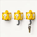 Two yellow block-style key hooks designed like Super Mario question blocks. Yellow Mystery Box hidden hook key holder with white question mark design