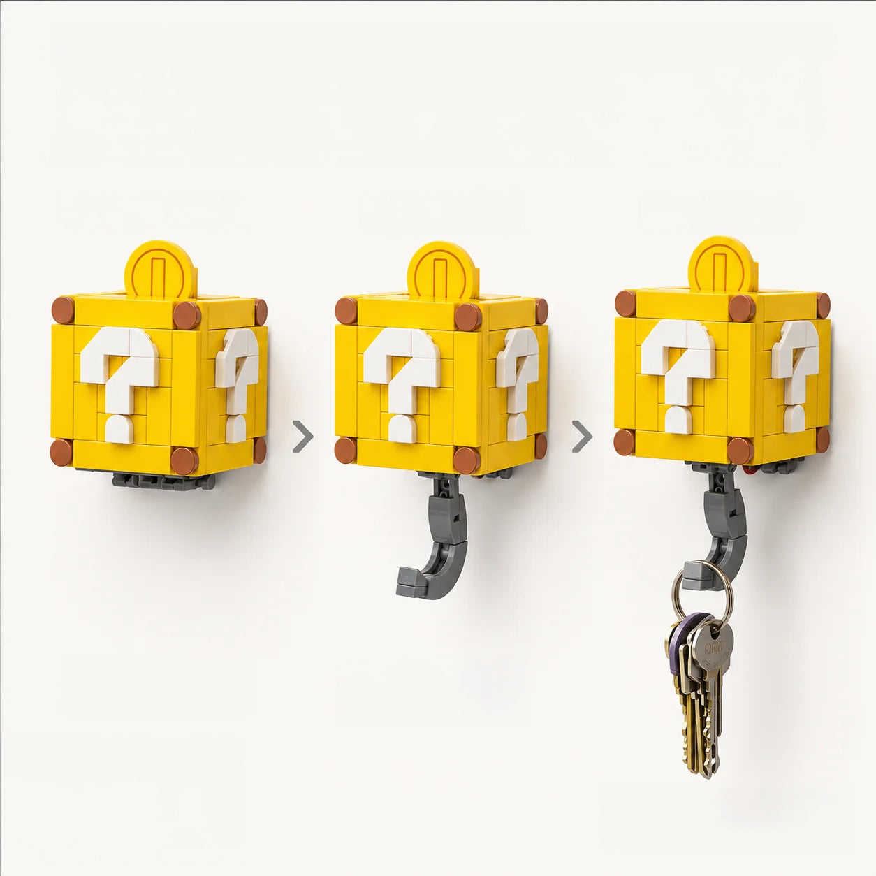 Two yellow block-style key hooks designed like Super Mario question blocks. Yellow Mystery Box hidden hook key holder with white question mark design