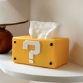 yellow retro question block tissue box cover with white question mark design and compact rectangular shape