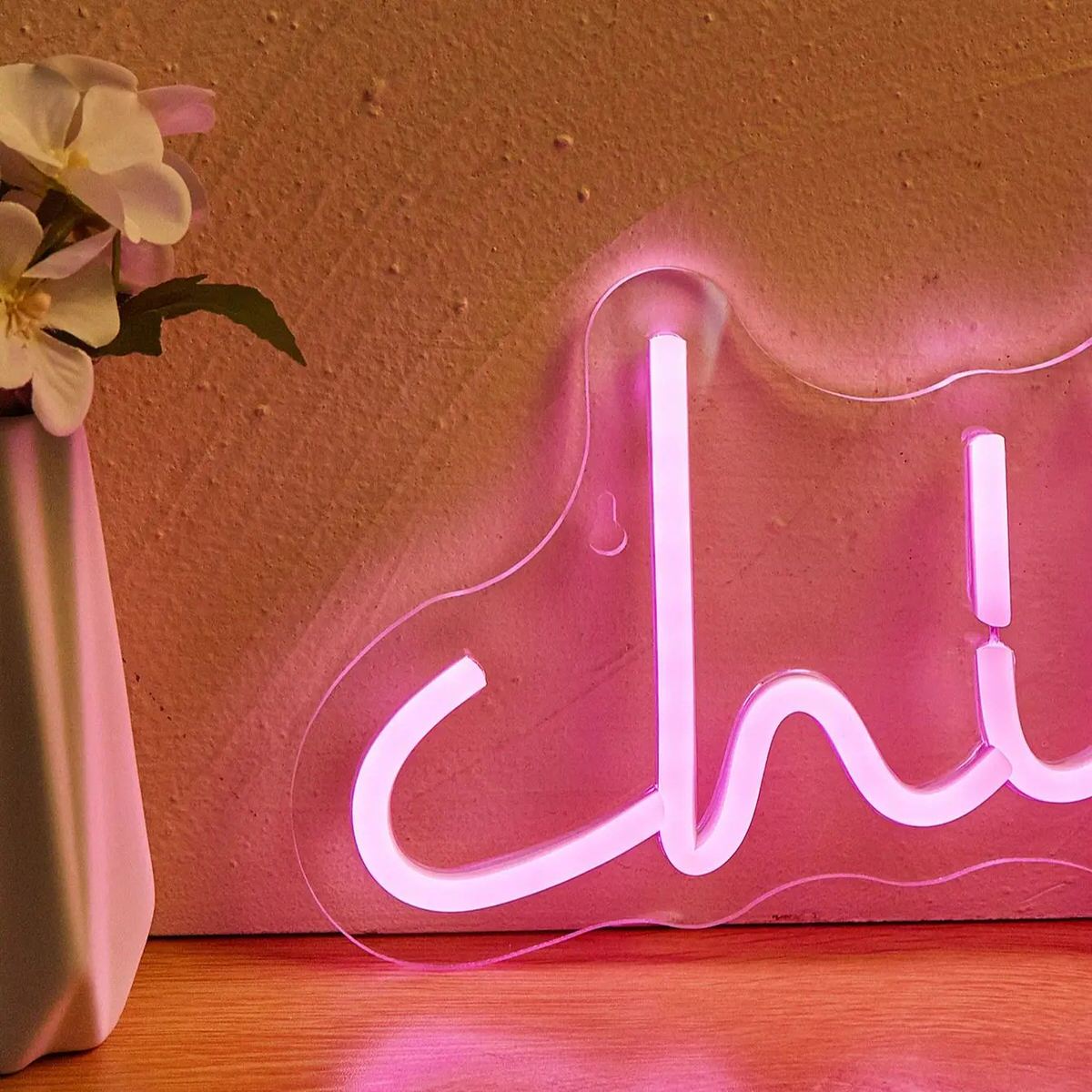Pink Chill LED neon wall sign in cursive lettering mounted on clear acrylic backing with USB cable.