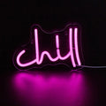Pink Chill LED neon wall sign in cursive lettering mounted on clear acrylic backing with USB cable.
