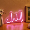 Pink Chill LED neon wall sign in cursive lettering mounted on clear acrylic backing with USB cable.