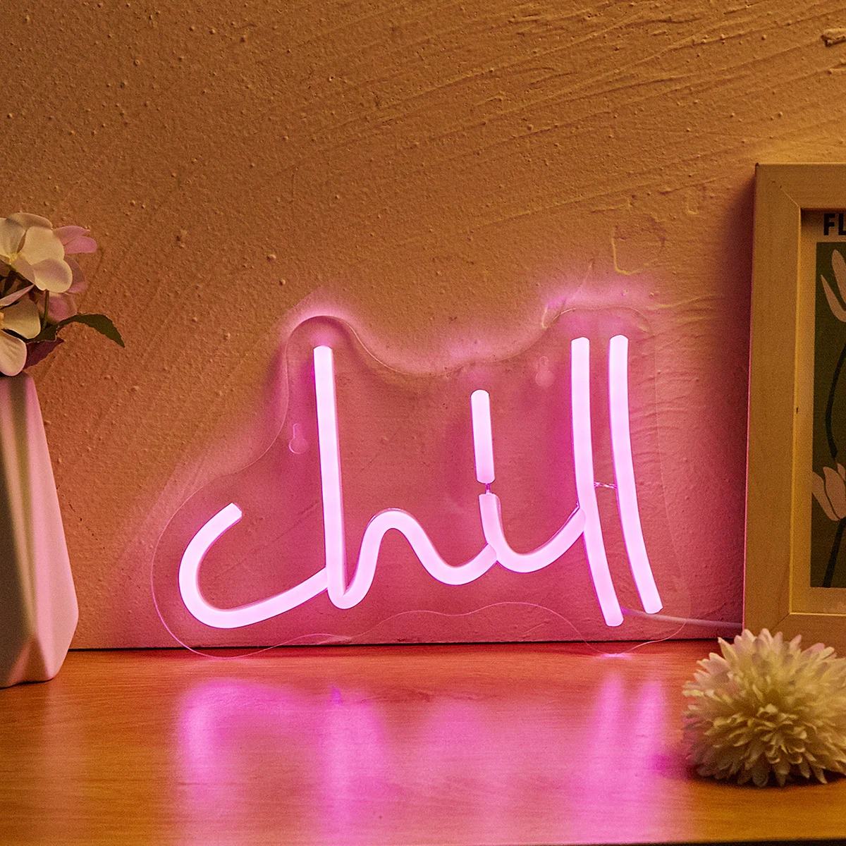 Pink Chill LED neon wall sign in cursive lettering mounted on clear acrylic backing with USB cable.