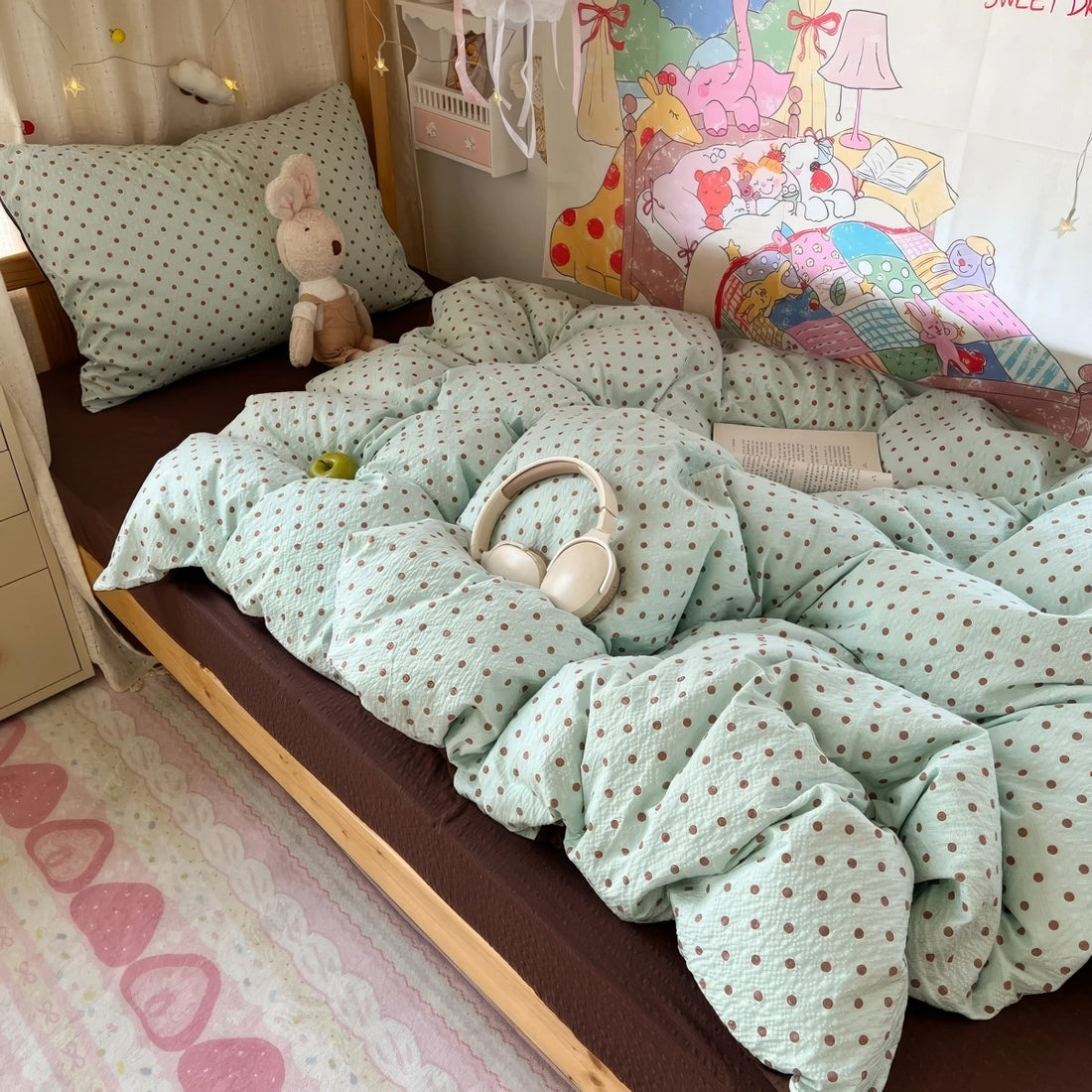 Mint green bubble crinkle bedding set with brown polka dots on a cozy bedroom bed