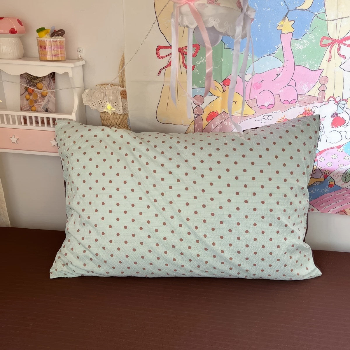 Mint green bubble crinkle bedding set with brown polka dots on a cozy bedroom bed