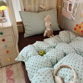 Mint green bubble crinkle bedding set with brown polka dots on a cozy bedroom bed