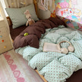 Mint green bubble crinkle bedding set with brown polka dots on a cozy bedroom bed