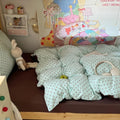 Mint green bubble crinkle bedding set with brown polka dots on a cozy bedroom bed