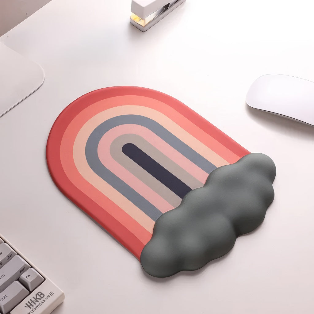 A rainbow-themed ergonomic wrist rest set, including a cloud-cushioned mouse pad and a matching keyboard wrist support, designed with a gradient rainbow pattern and soft white cloud accents