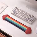 A rainbow-themed ergonomic wrist rest set, including a cloud-cushioned mouse pad and a matching keyboard wrist support, designed with a gradient rainbow pattern and soft white cloud accents