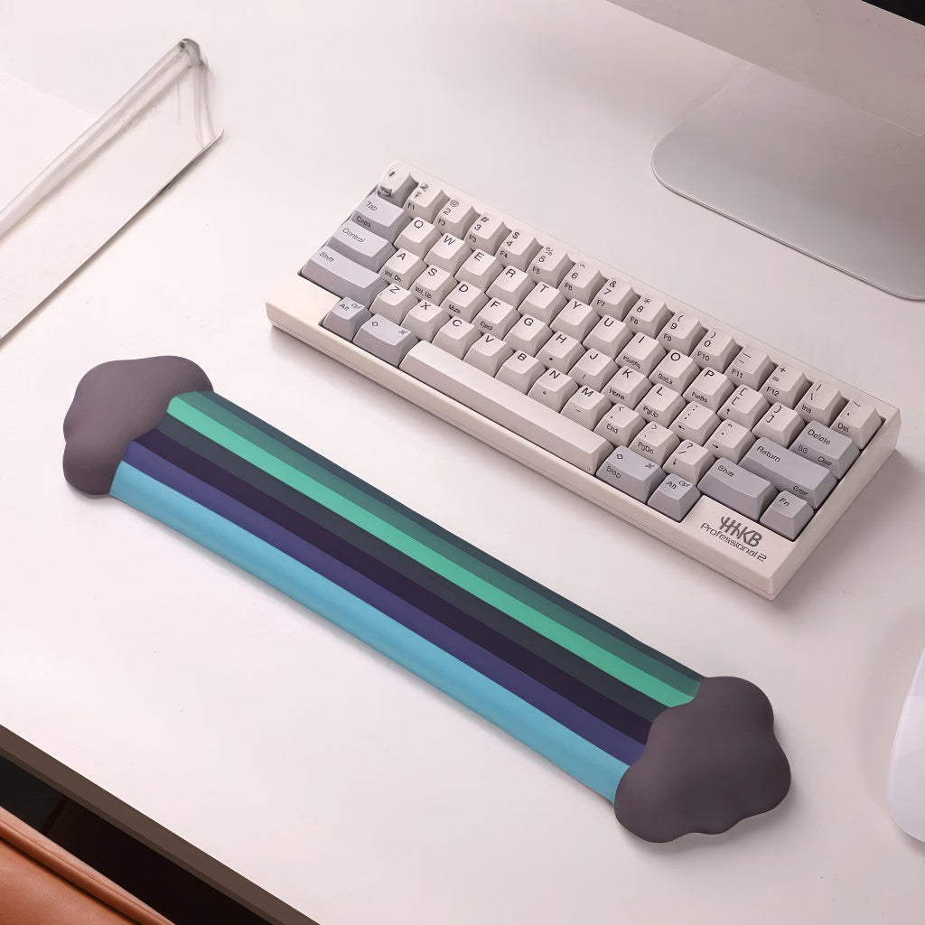 A rainbow-themed ergonomic wrist rest set, including a cloud-cushioned mouse pad and a matching keyboard wrist support, designed with a gradient rainbow pattern and soft white cloud accents