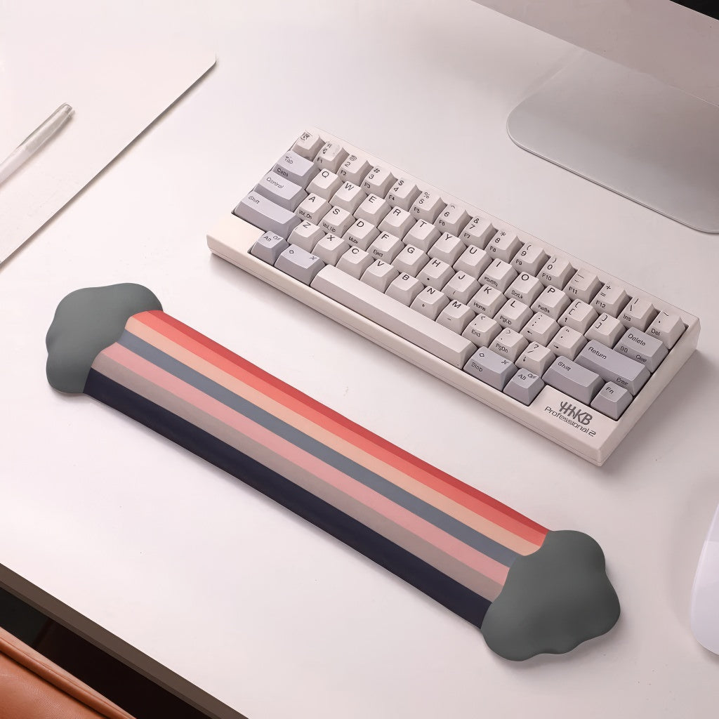 A rainbow-themed ergonomic wrist rest set, including a cloud-cushioned mouse pad and a matching keyboard wrist support, designed with a gradient rainbow pattern and soft white cloud accents