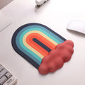 A rainbow-themed ergonomic wrist rest set, including a cloud-cushioned mouse pad and a matching keyboard wrist support, designed with a gradient rainbow pattern and soft white cloud accents