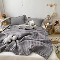 Ruffled summer quilt set with chevron stitching and ruffle trim, available in pastel and neutral colors