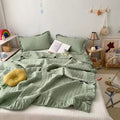 Ruffled summer quilt set with chevron stitching and ruffle trim, available in pastel and neutral colors