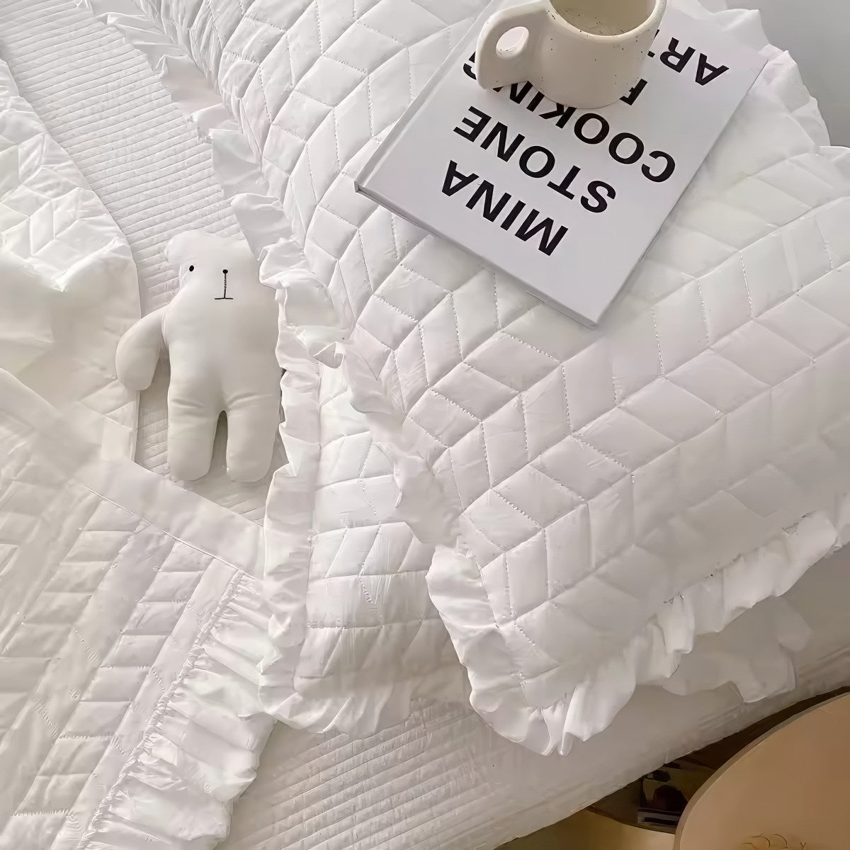 Ruffled summer quilt set with chevron stitching and ruffle trim, available in pastel and neutral colors