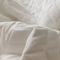 Ruffled summer quilt set with chevron stitching and ruffle trim, available in pastel and neutral colors