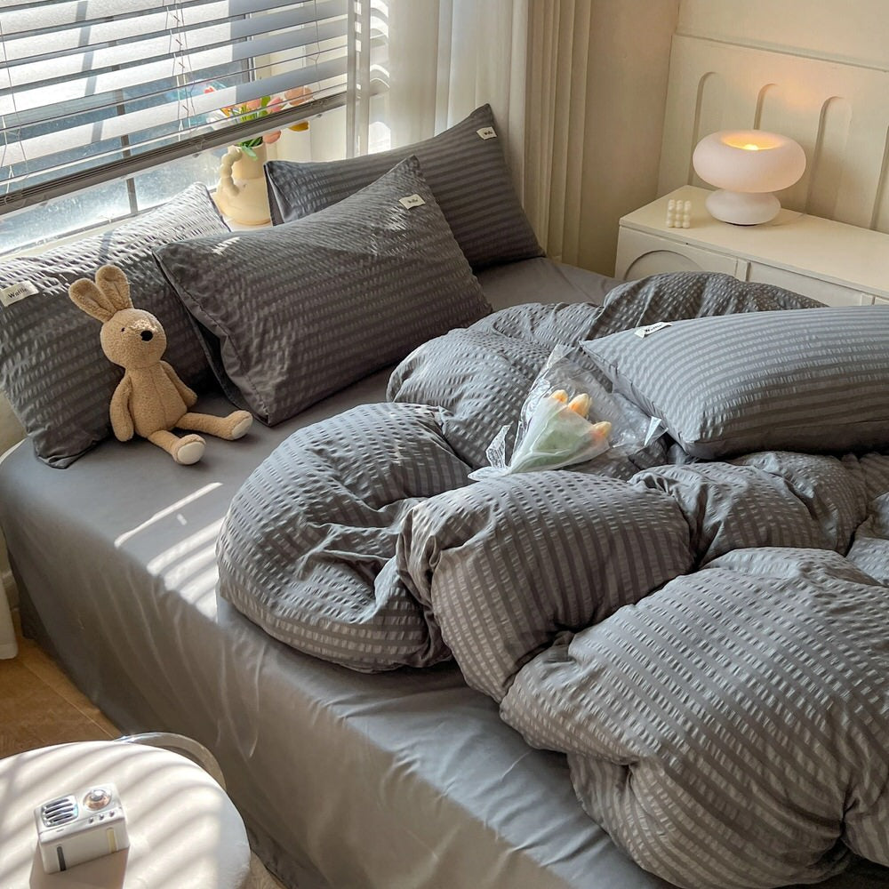 grey color bedding set with waffled duvet cover and shams and matching flat sheet roomtery