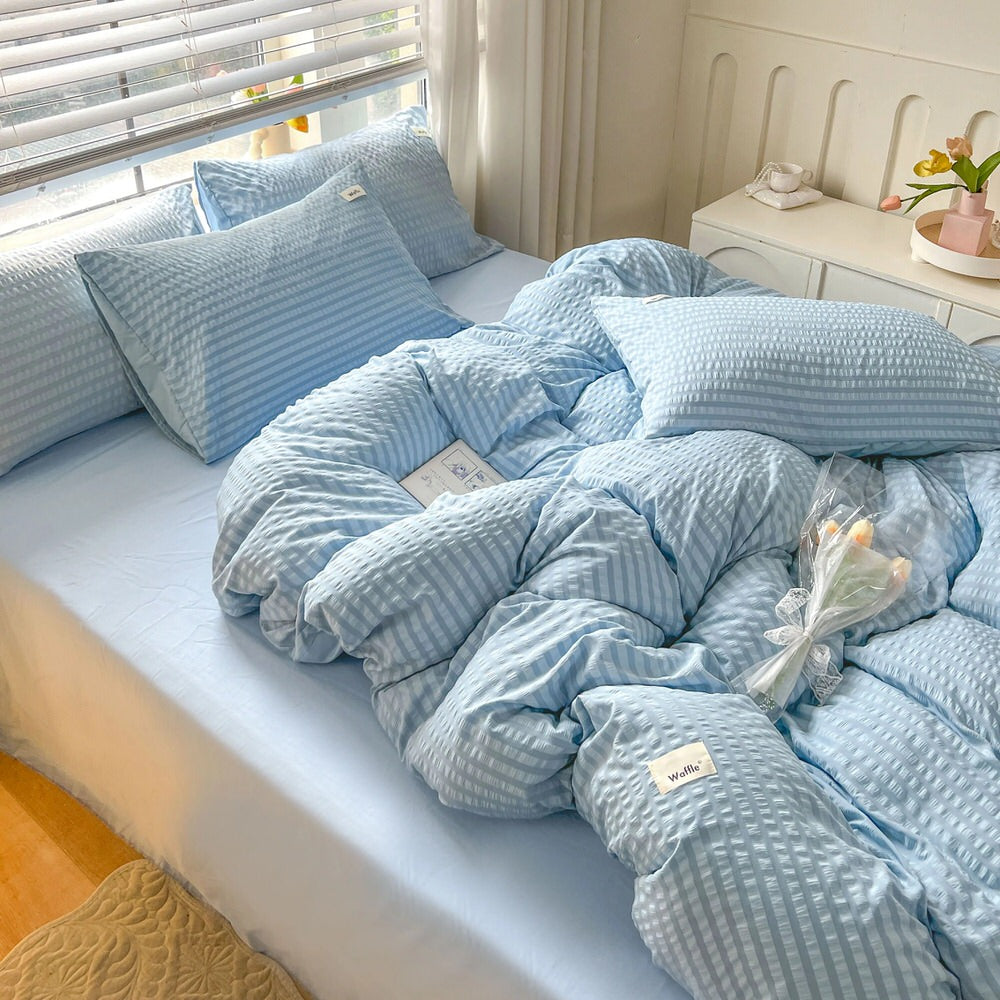 blue color bedding set with waffled duvet cover and shams and matching flat sheet roomtery
