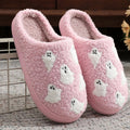 Plush pink ghost slippers with white ghost patterns and soft fuzzy lining