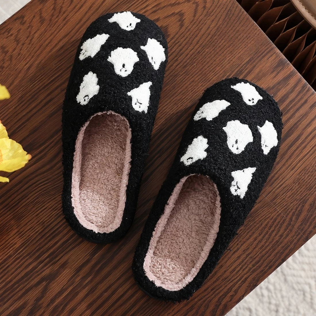 Plush black ghost slippers with white ghost patterns and soft fuzzy lining