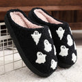 Plush black ghost slippers with white ghost patterns and soft fuzzy lining