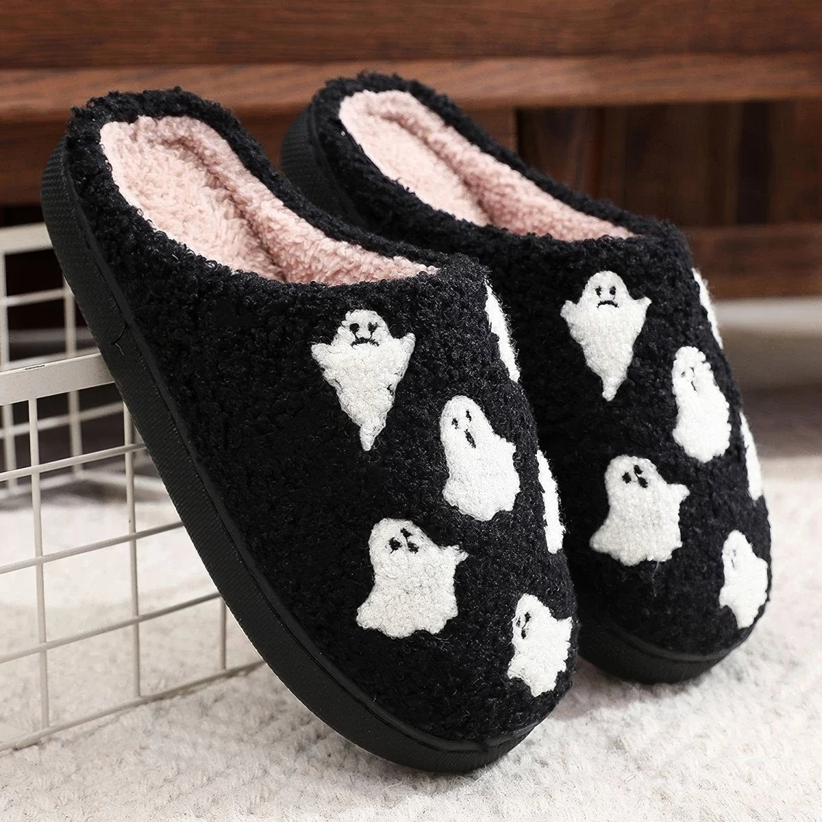 Plush black ghost slippers with white ghost patterns and soft fuzzy lining