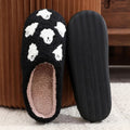 Plush black ghost slippers with white ghost patterns and soft fuzzy lining