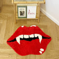 aesthetic accent tufted rug in the shape of red lips with an open mouth, featuring white vampire fangs and black shading inside the mouth