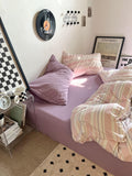 pastel pink striped bedding duvet cover set with matching pastel purple pillow case and fitted sheet