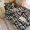 Black and brown plaid bubble crinkle bedding set with matching pillows on a cozy bedroom bed