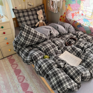 Black and brown plaid bubble crinkle bedding set with matching pillows on a cozy bedroom bed