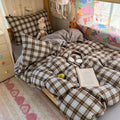 Black and brown plaid bubble crinkle bedding set with matching pillows on a cozy bedroom bed