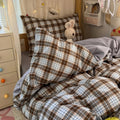 Black and brown plaid bubble crinkle bedding set with matching pillows on a cozy bedroom bed